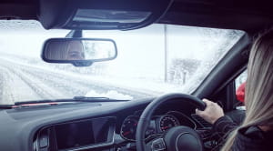 Winter driving tips woman car snowy